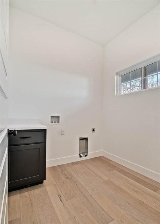 washroom featuring hookup for a washing machine, baseboards, light wood-type flooring, cabinet space, and electric dryer hookup