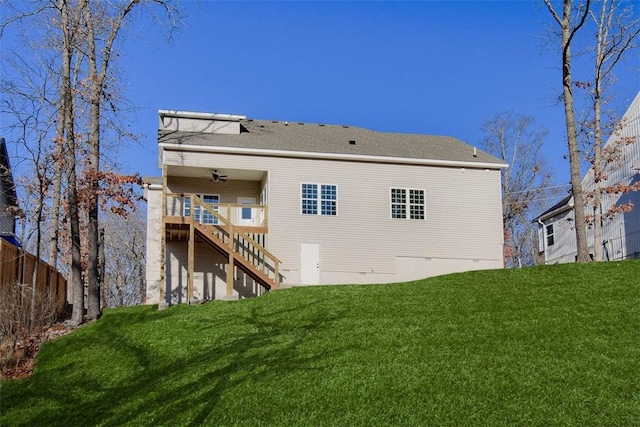 back of property with stairs, a lawn, fence, and a ceiling fan