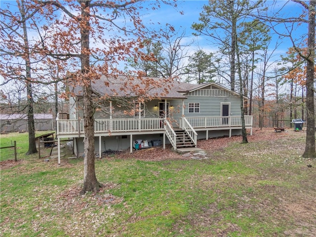 view of front of home featuring stairs, a front lawn, a shingled roof, and a wooden deck