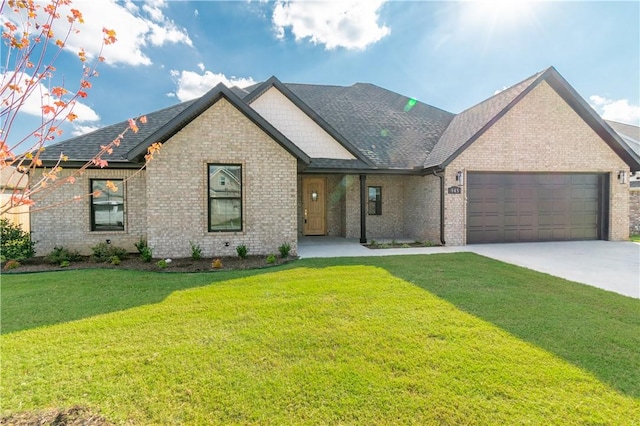 view of front facade featuring a garage, concrete driveway, brick siding, and a front yard