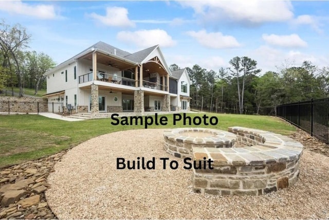 rear view of property with a lawn, a ceiling fan, a balcony, an attached garage, and fence