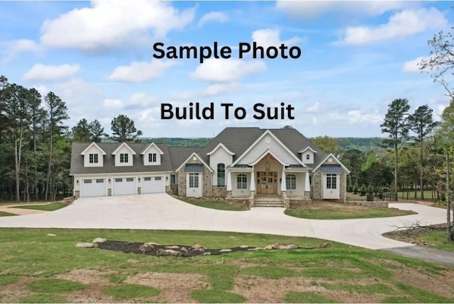 view of front of property with an attached garage, driveway, and a front lawn