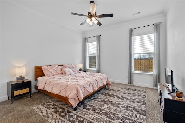 carpeted bedroom with visible vents, crown molding, baseboards, and ceiling fan