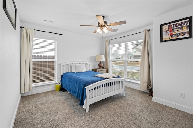 bedroom with baseboards, visible vents, ceiling fan, and carpet flooring