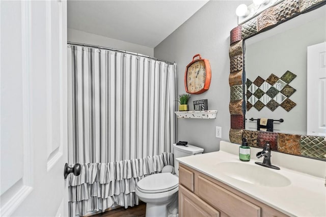 full bath featuring a shower with shower curtain, vanity, toilet, and wood finished floors