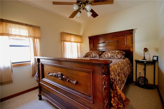 bedroom featuring ceiling fan, baseboards, and light colored carpet