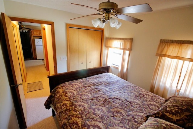 bedroom with freestanding refrigerator, multiple windows, and carpet