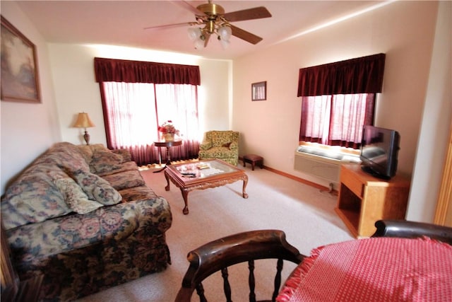 living area featuring ceiling fan, carpet flooring, and baseboards