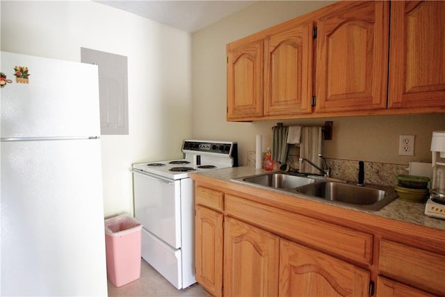 kitchen featuring light countertops, white appliances, a sink, and brown cabinets