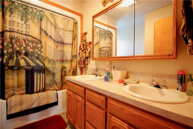 bathroom with double vanity, shower / bath combo, and a sink