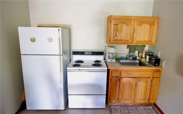 kitchen with white appliances, light countertops, and a sink