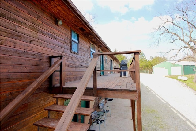 deck with an outbuilding and a detached garage