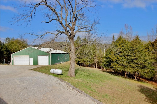 view of yard with a garage and an outdoor structure