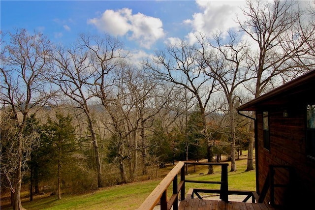 deck featuring a yard and a forest view