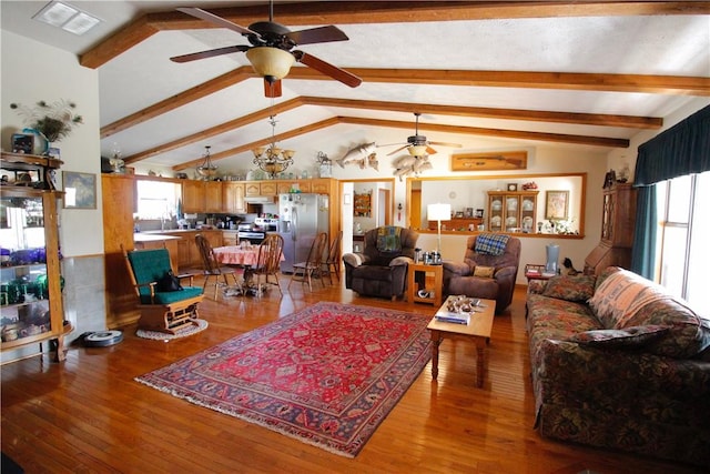 living room featuring vaulted ceiling with beams, ceiling fan, visible vents, and wood finished floors