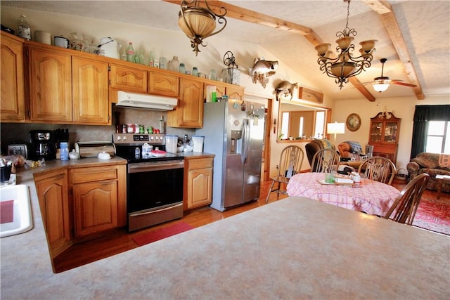 kitchen with lofted ceiling with beams, under cabinet range hood, stainless steel appliances, a sink, and open floor plan