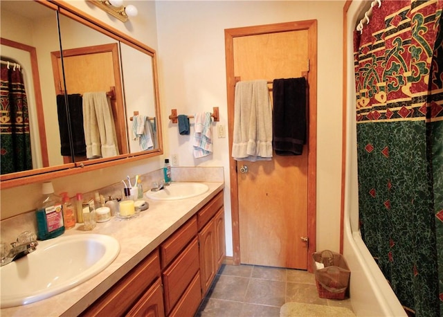 bathroom with curtained shower, double vanity, a sink, and tile patterned floors