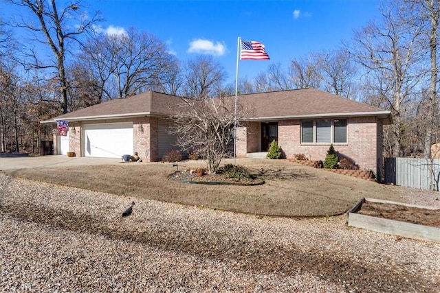 ranch-style home with driveway, brick siding, an attached garage, and fence