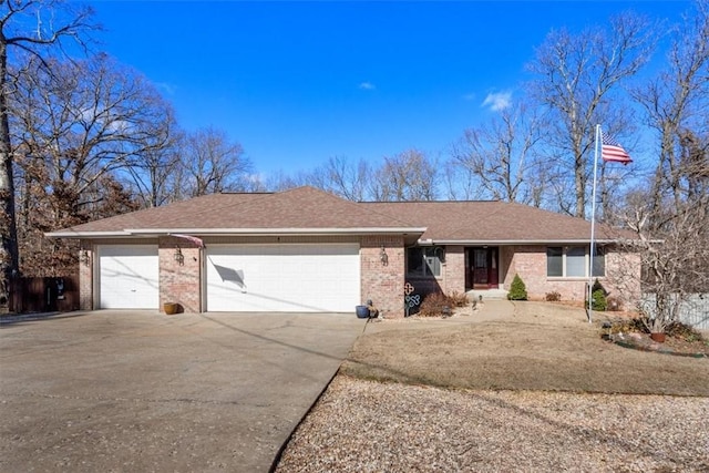 ranch-style home with a garage, driveway, brick siding, and a shingled roof