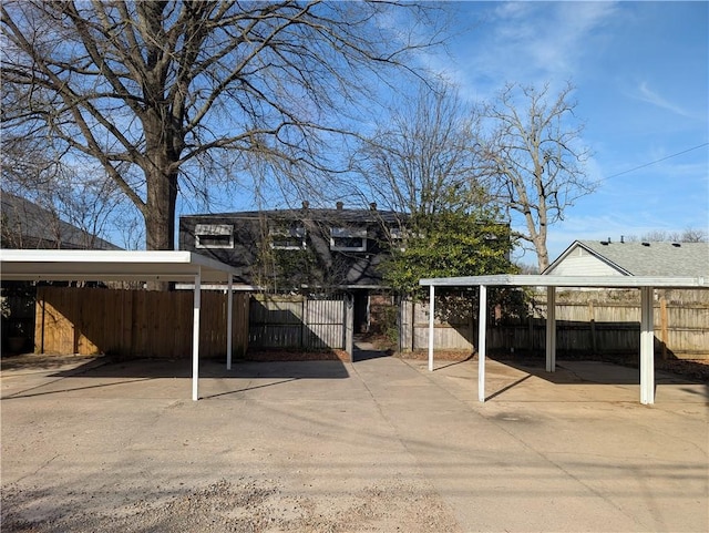 view of car parking featuring a carport and fence