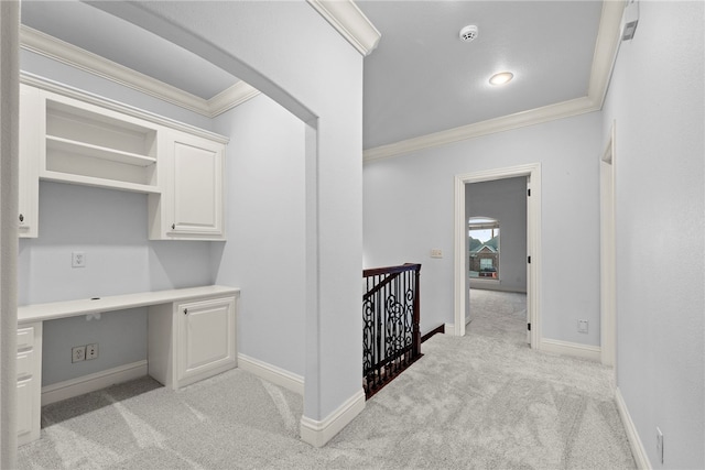 office featuring ornamental molding, light colored carpet, and built in study area