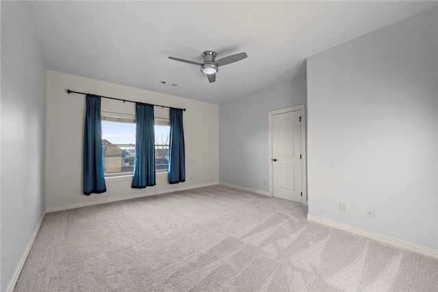 unfurnished room with ceiling fan, visible vents, baseboards, and light carpet