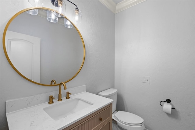 half bath featuring vanity, toilet, a textured wall, and ornamental molding