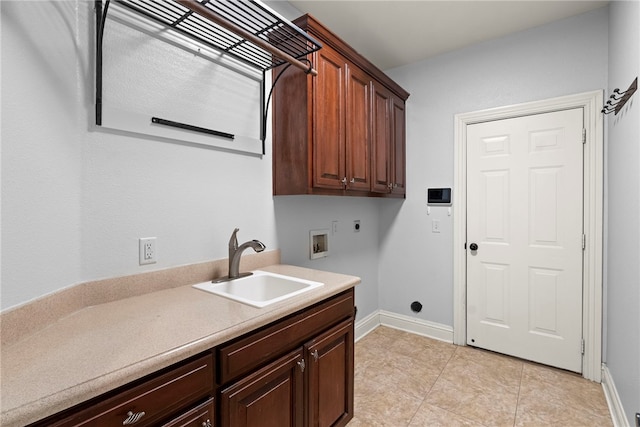 laundry area with baseboards, hookup for a washing machine, cabinet space, electric dryer hookup, and a sink