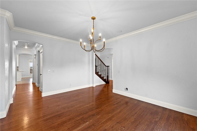 unfurnished dining area with crown molding, baseboards, stairway, wood finished floors, and arched walkways