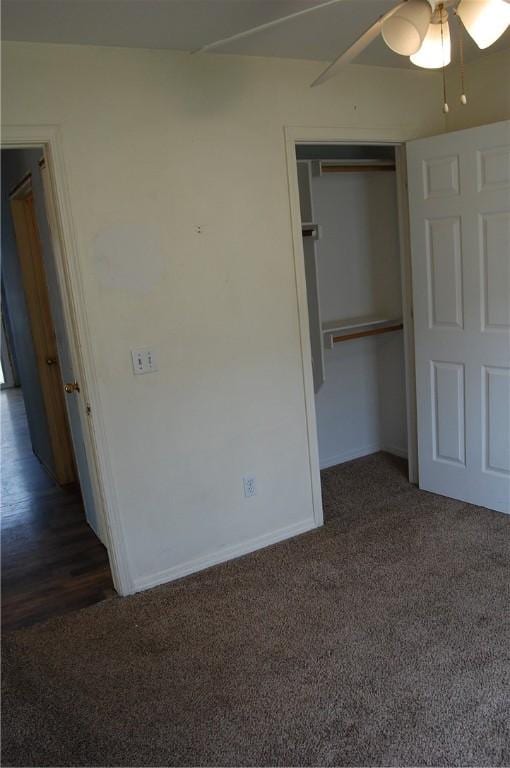 unfurnished bedroom with carpet floors, a closet, and baseboards