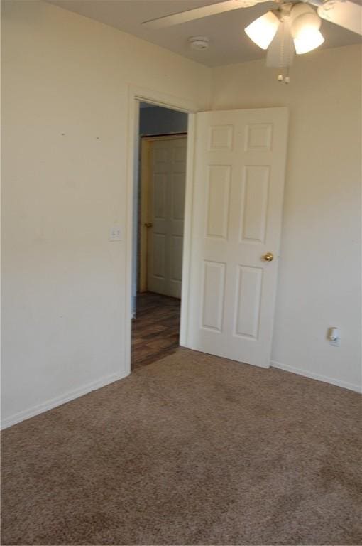 unfurnished bedroom featuring carpet, ceiling fan, and baseboards