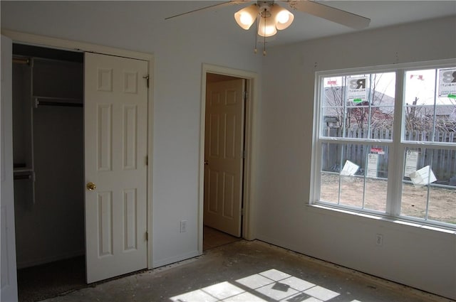 unfurnished bedroom featuring a closet, multiple windows, and ceiling fan