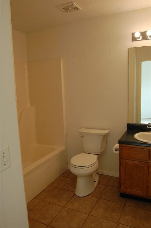 bathroom featuring toilet, vanity, visible vents, and tile patterned floors