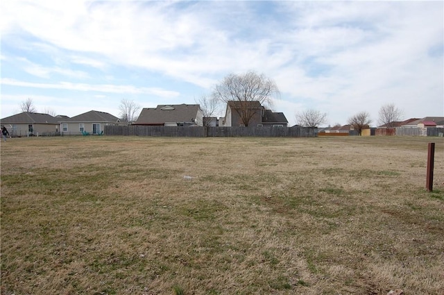 view of yard featuring a residential view and fence