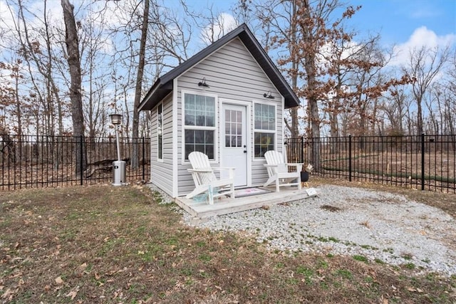 view of outdoor structure with a fenced backyard and an outdoor structure