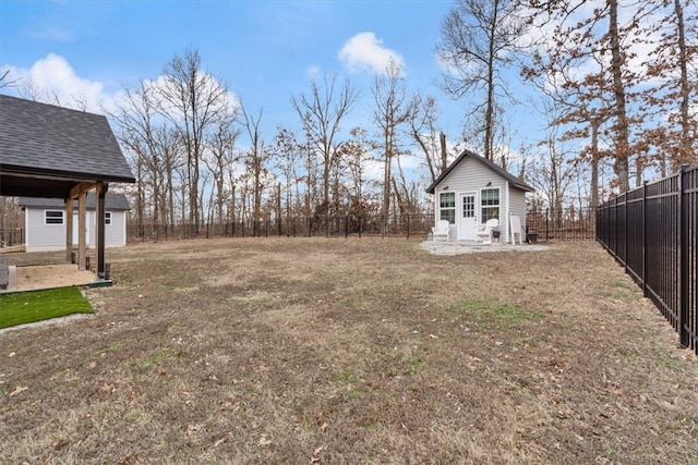 view of yard featuring an outdoor structure and a fenced backyard