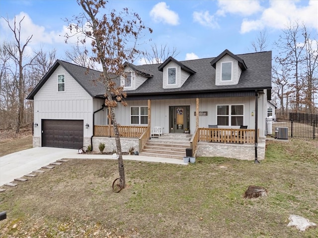 view of front of property with a shingled roof, concrete driveway, an attached garage, covered porch, and board and batten siding