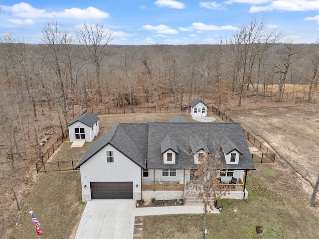 57 Cromarty Dr, Bella Vista, AR 72715 - view of front of property with concrete driveway, a porch, an attached garage, and a shingled roof
