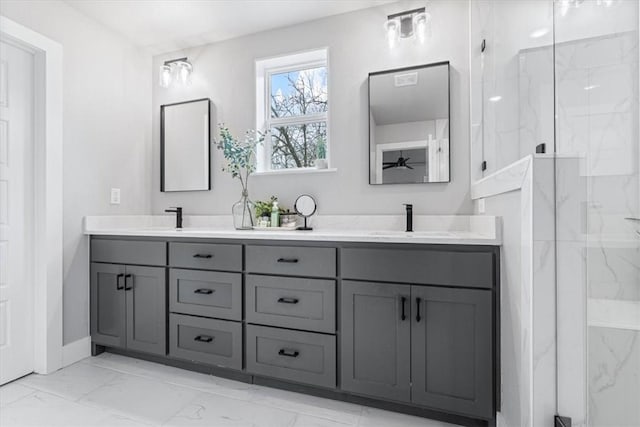 bathroom with marble finish floor, double vanity, a sink, and a marble finish shower