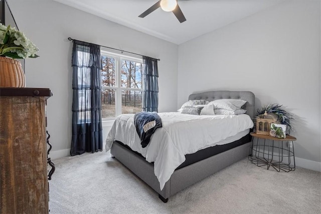 carpeted bedroom featuring a ceiling fan and baseboards