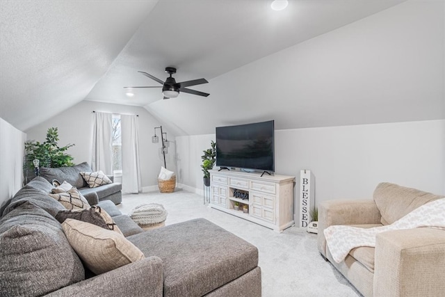 living room featuring lofted ceiling, ceiling fan, carpet, and baseboards