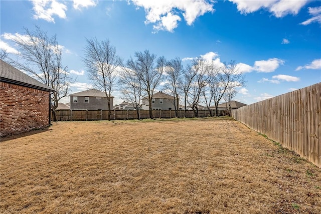 view of yard with a fenced backyard