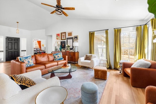 living room featuring high vaulted ceiling, a ceiling fan, and wood finished floors