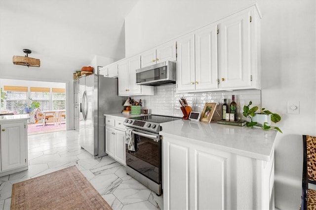 kitchen with stainless steel appliances, white cabinets, marble finish floor, light countertops, and decorative backsplash