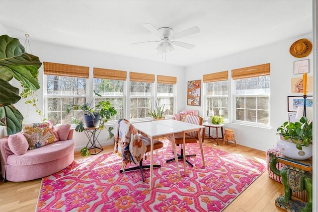 sunroom featuring a ceiling fan