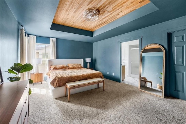 carpeted bedroom featuring a tray ceiling and wood ceiling