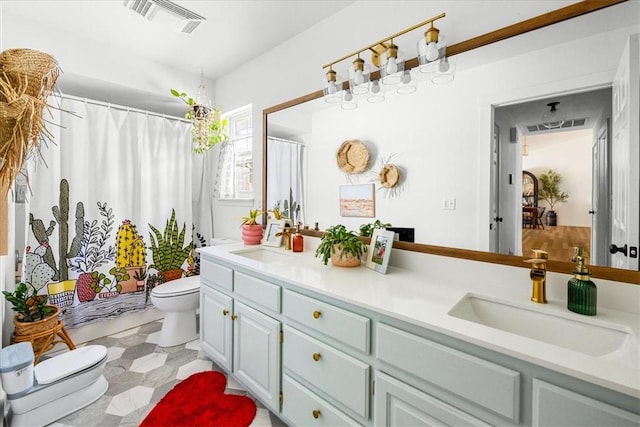 full bathroom with toilet, double vanity, visible vents, and a sink