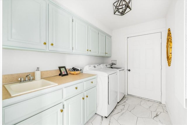 clothes washing area featuring washer and dryer, marble finish floor, cabinet space, and a sink