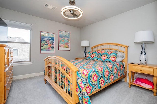 carpeted bedroom featuring visible vents and baseboards