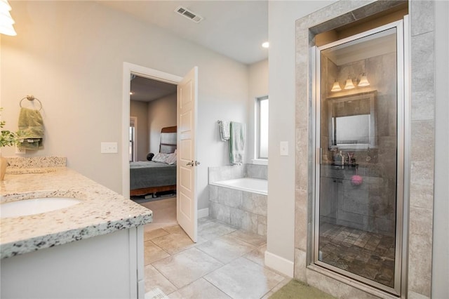 bathroom with a stall shower, vanity, ensuite bath, and a bath